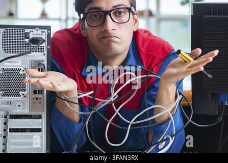 Computer mechanic works on repairing computers in an IT workshop Stock Photo