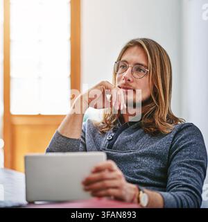 Man, thinking and vision in office with tablet, plan and consider AI software for UX design project. Person, problem solving and digital designer in Stock Photo