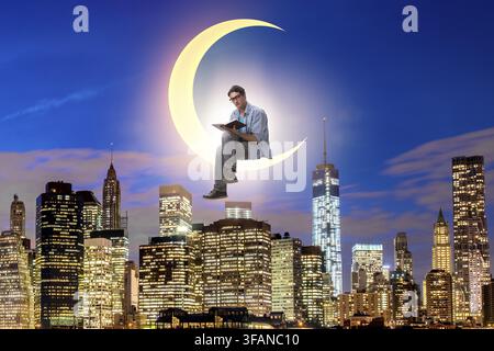 The student is reading a book on the crescent Stock Photo