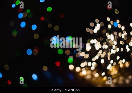 Abstract background featuring colorful bokeh circles and glowing lights creating a festive atmosphere. Stock Photo