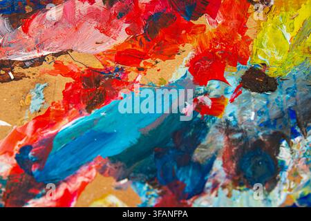 Vibrant abstract paint texture with thick layered strokes across an artist palette Stock Photo