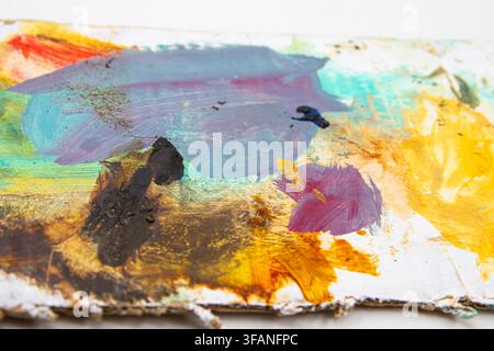 Vibrant abstract paint texture with thick layered strokes across an artist palette Stock Photo