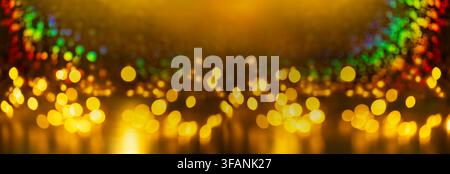 Golden bokeh lights with colorful rainbow reflections and warm amber glow for festive celebration background and design Stock Photo