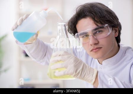 Young male biochemist working in laboratory Stock Photo