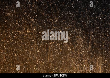 Warm brown scratched and dusty surface with vertical distressed marks and golden glow for vintage grunge texture background Stock Photo