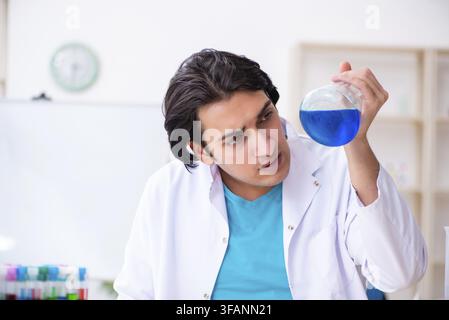 Young male chemist working in laboratory Stock Photo