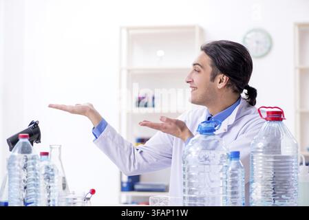 The young male chemist is experimenting in the laboratory Stock Photo