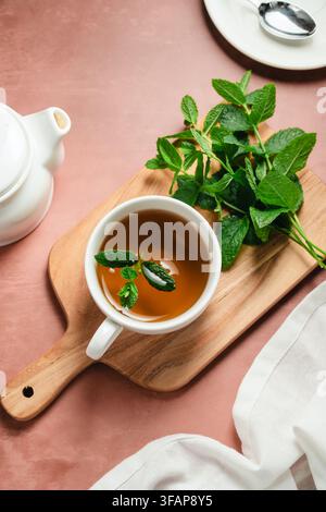 Flat lay of fresh mint tea on a wooden board Stock Photo