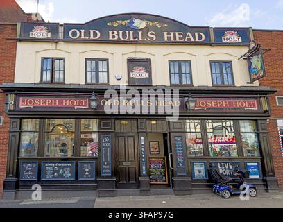 The Old Bulls Head, a Joseph Holt brewery pub in Eccles town centre, Salford, with a mobility scooter parked outside in August 2026. Stock Photo