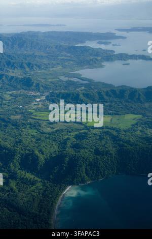 Aerial view of a lush green peninsula surrounded by the calm waters of ...