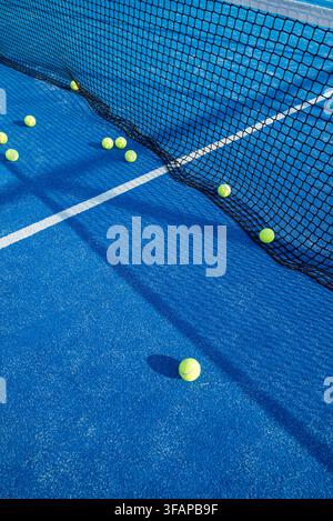 Vibrant sports background featuring scattered yellow balls on a highly textured blue ground Stock Photo