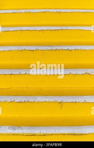 Yellow painted steps showing textured surface with chipping paint details Stock Photo