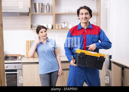 Young male mechanic repairs faucet Stock Photo