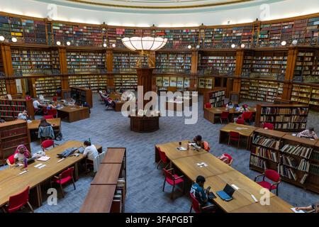 High angle view of people working at wooden study tables in the circular Picton Reading Room inside Liverpool Central Library, Liverpool. Stock Photo