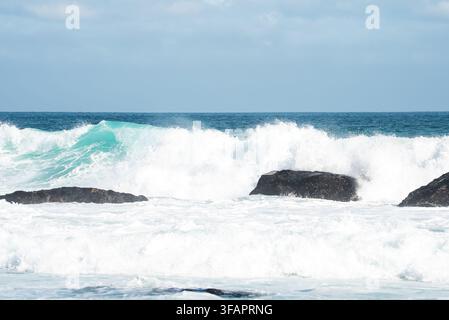 Ocean waves crashing against coastal rocks in Cape Town Stock Photo
