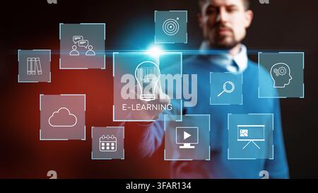 E learning concepts with a man interacting with digital icons in a modern setting Stock Photo