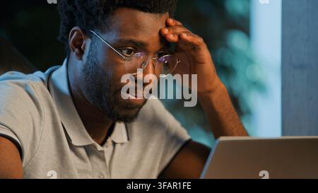 Close up trouble African American business man looking at laptop thinking about problem failure online stressed ethnic businessman male manager worker Stock Photo