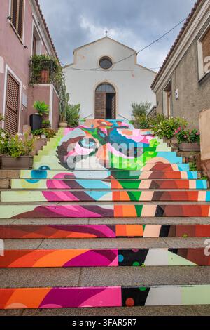 The colorfully painted staircase (Scalinata di Santa Lucia) leading to the Santa Lucia Church in Arzachena, Sardinia, Italy Stock Photo