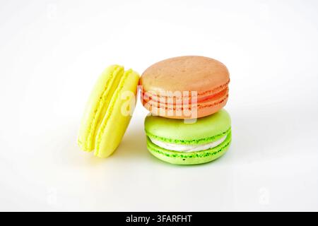 Colorful French Macarons Stacked on a White Background Stock Photo