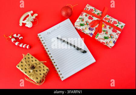 Wish List with Gifts and Holiday Decorations on Red Background lunar new year Stock Photo