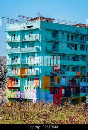 Colorfully repainted balconies and facade of a Soviet-era Brezhnevka apartment block in Chiatura, Georgia. Stock Photo