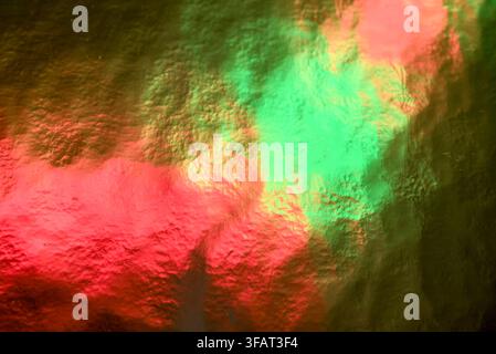 A striking red and green foil texture abstract backdrop. Stock Photo