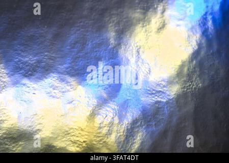 bright yellow and blue foil texture abstract backdrop with gloss. Stock Photo
