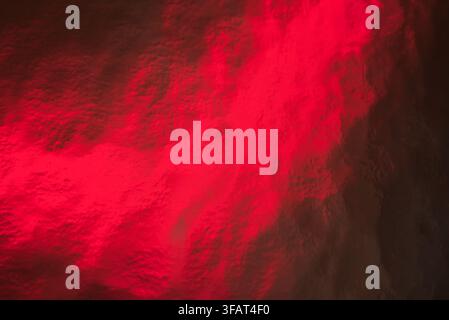 A deep red foil texture abstract background with metallic sheen. Stock Photo