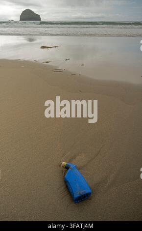 Plastic bottle washed up on remote beach. Cornwall, UK Stock Photo