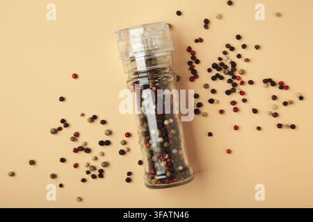Plastic pepper mill on beige background. Top view Stock Photo