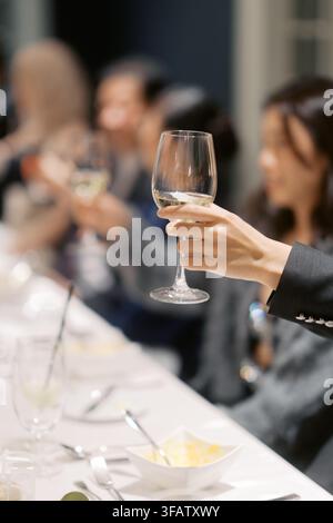 Elegant dinner party toast with wine glasses Stock Photo