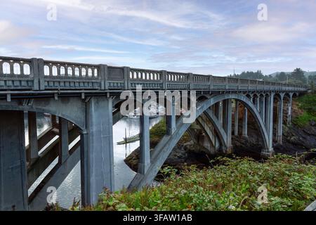 Highway 101 Arch bridge over the entrance of the Depoe Bay Oregon Harbor Stock Photo