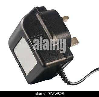 black uk power adapter plug isolated white background, plastic casing with metal pins and attached cable in close-up view Stock Photo