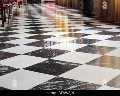 Polished marble floor with a classic checkerboard pattern providing reflections Stock Photo