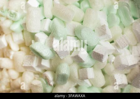 Close-up image of packing peanuts and foam cushioning materials in different shapes and colors, suitable for shipping and protective packaging needs Stock Photo