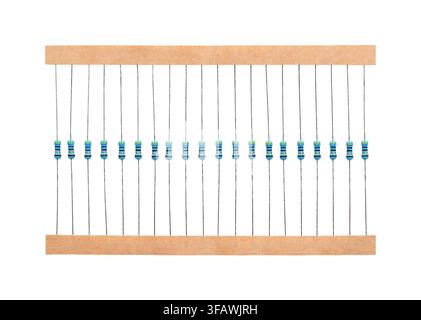 Metal film resistors on tape. 20 axial-leaded resistors, through-hole electronic components with wire leads extending straight out from both ends. Stock Photo