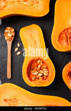 Butternut squash and wooden spoon arranged in graphic autumn composition. Seasonal food flat lay with pumpkin and harvest ingredient styling Stock Photo