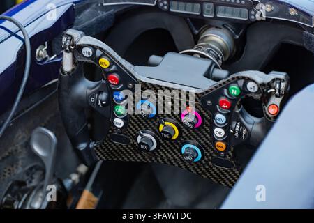 Precision engineering perspective of a formula racing vehicle steering mechanism with multi-function buttons, telemetry display, and paddle shifters Stock Photo
