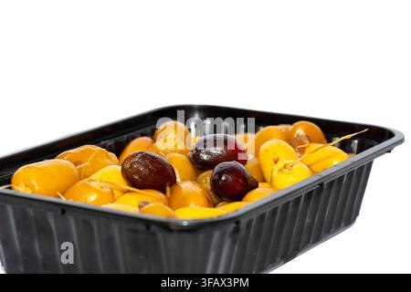 Fresh ripe khalal dates, yellow and red, packed in black tray, isolated white Stock Photo