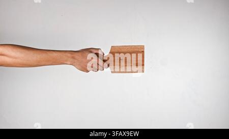 Hand Holding Small Wooden Cutting Board with Handle on white background Stock Photo