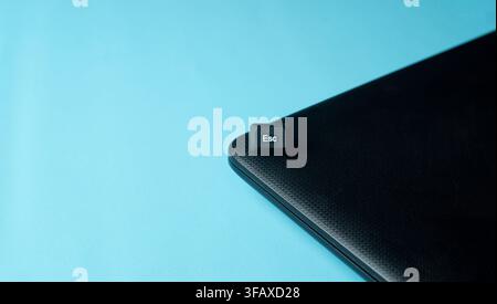 Minimal Esc keyboard key on a black laptop corner with blue background, representing escape, exit, pause, reset, and freedom concept. Stock Photo