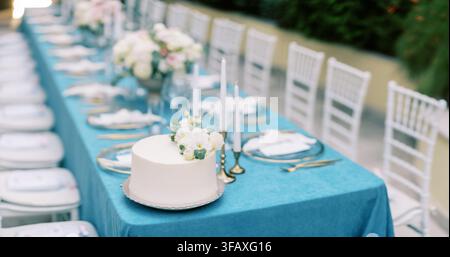Elegant wedding cake on decorated banquet table Stock Photo