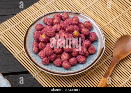 Purple coated crispy peanuts served in small plate Stock Photo