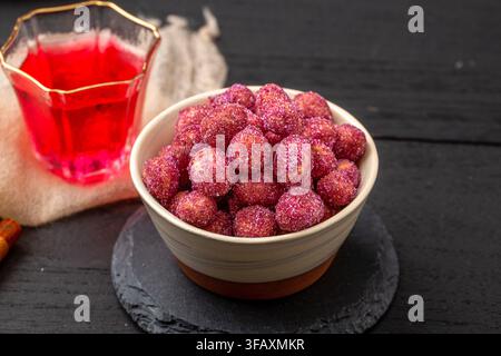 Purple coated crispy peanuts served in small plate Stock Photo