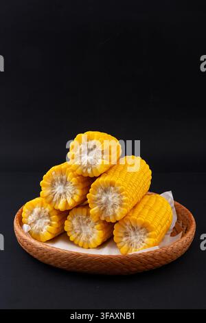 Boiled yellow waxy sweet corn cobs stack isolated on white background Stock Photo