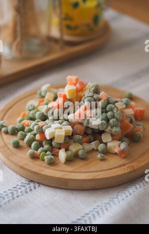 Frozen vegetables on a wooden board with a white background Stock Photo