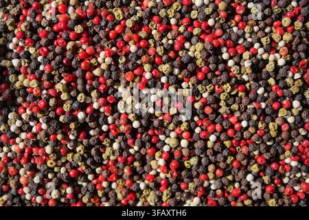 Colorful mix of different peppercorns on a surface Stock Photo