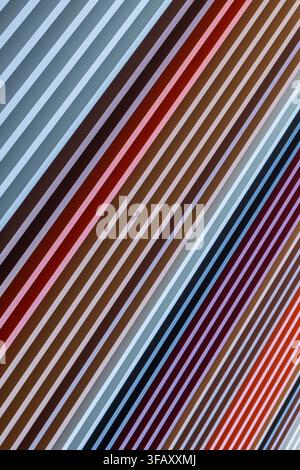 Upward view of facade clad in vertical multicolored fins, strong architectural pattern, Sydney, Australia. Stock Photo