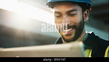 Tablet, happy and construction worker on site with research update on maintenance, repairs or building. Digital technology, man and civil engineer Stock Photo