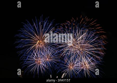 Colorful burst of blue and gold fireworks lighting up night sky, Sydney, Australia, new year celebration. Stock Photo